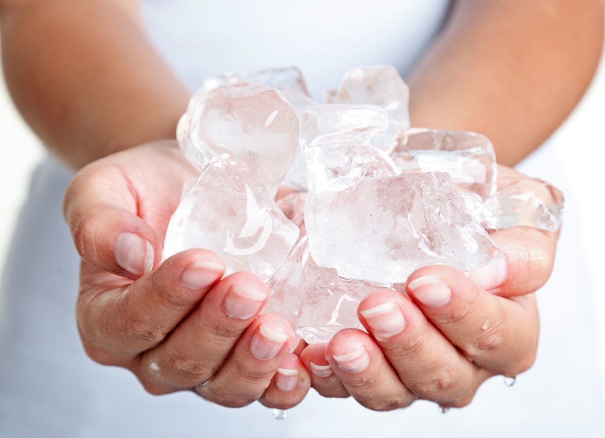 woman holding cubes of ice